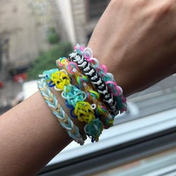 Model's wrist showing off more colorful rubber band bracelets