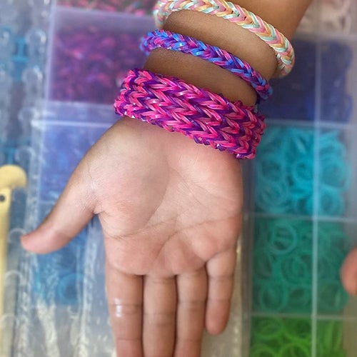 Reviewer's image of child's hand and wrist wearing rubber band bracelets