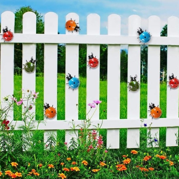 The patio/fence wall sculptures on a white fence