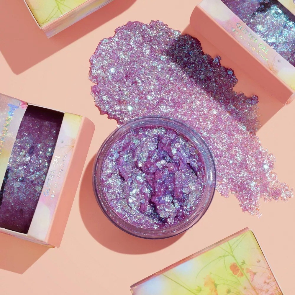 The purple glitter in a container next to a spread out slab to show the consistency