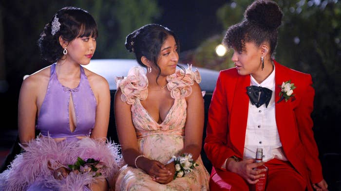 Devi and two others are wearing formal wear as they sit outside talking