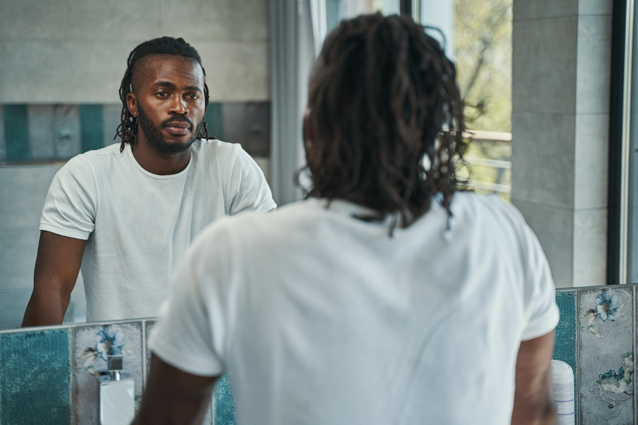 man looking at himself in the mirror