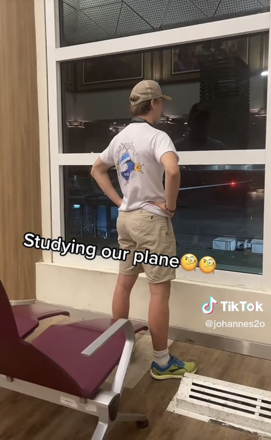 Airport Dad standing at the airport windows with his hands on his hips, with caption &quot;Studying our plane&quot; with monocle emoji