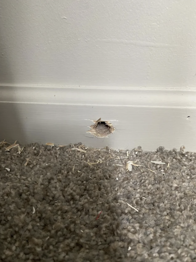 hole in the baseboard of a room
