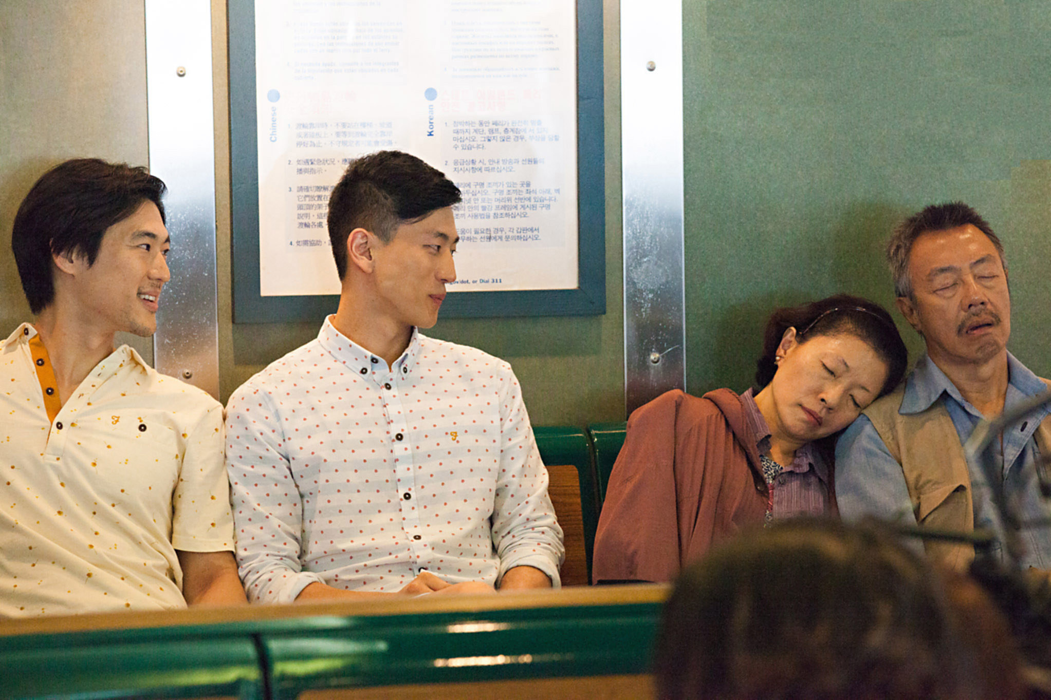 Two asian men looking at two asian couples sleeping