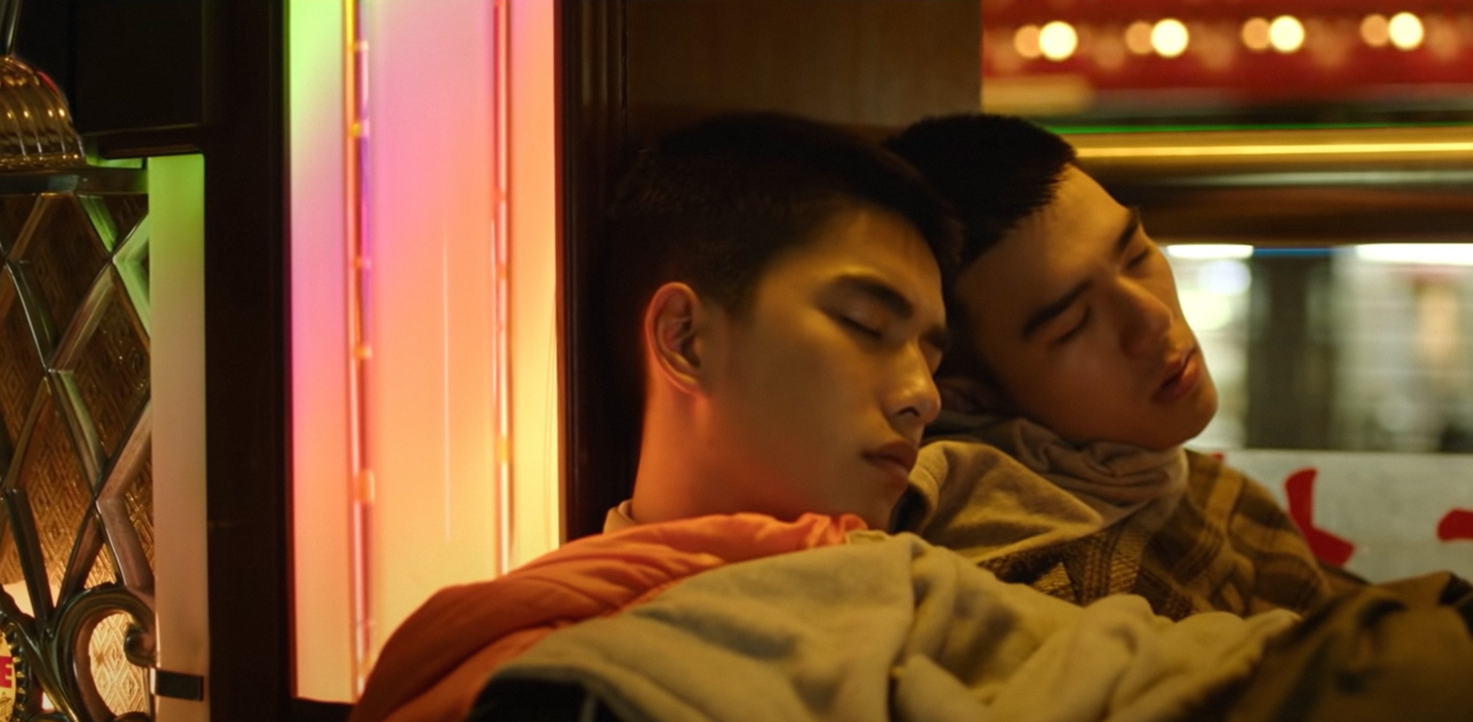 Two boys with their heads together sleeping