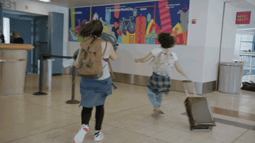 Two women running to a closed airport gate and hitting the airline rep with a shoe
