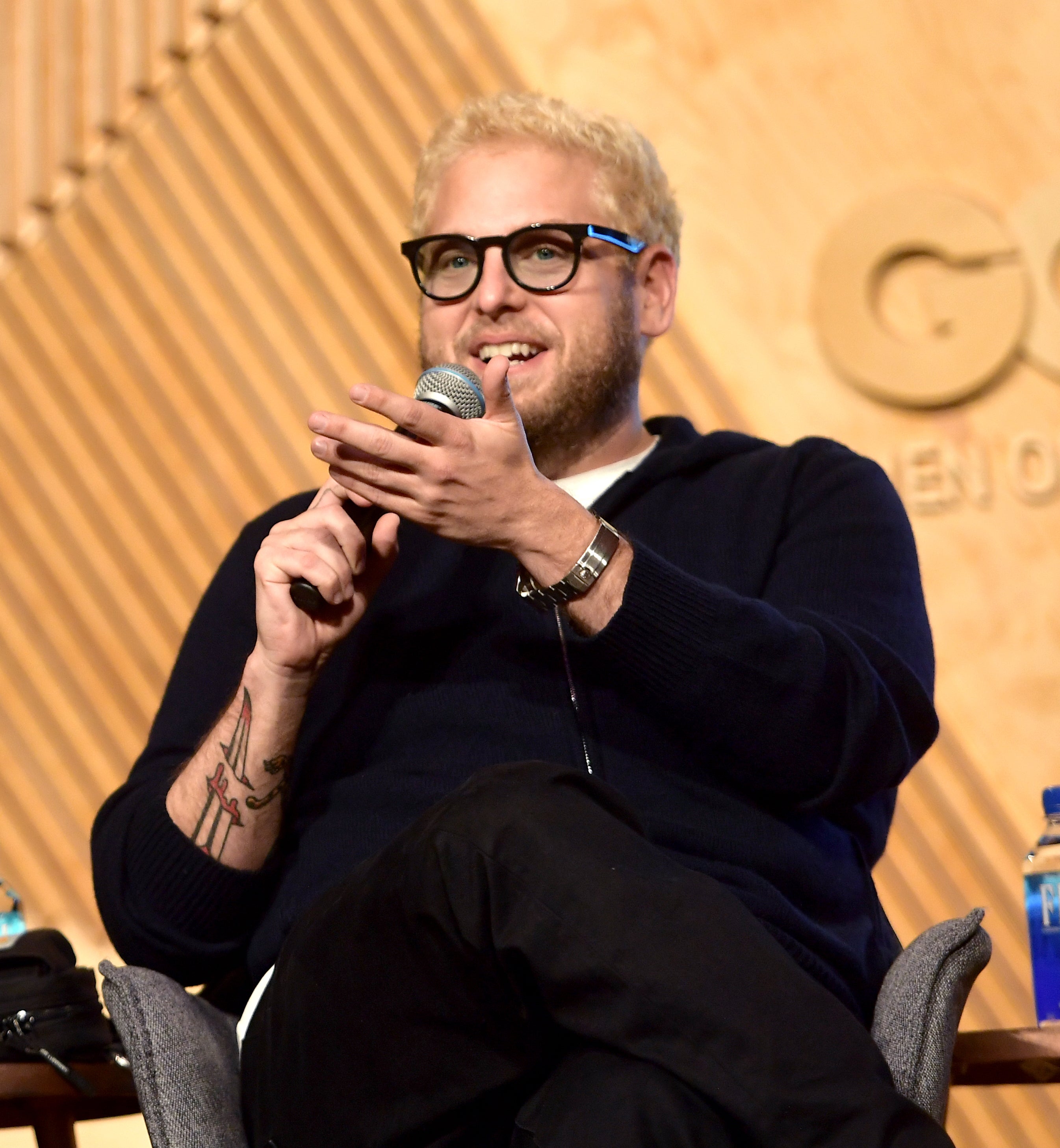 Close-up of Jonah sitting and holding a microphone