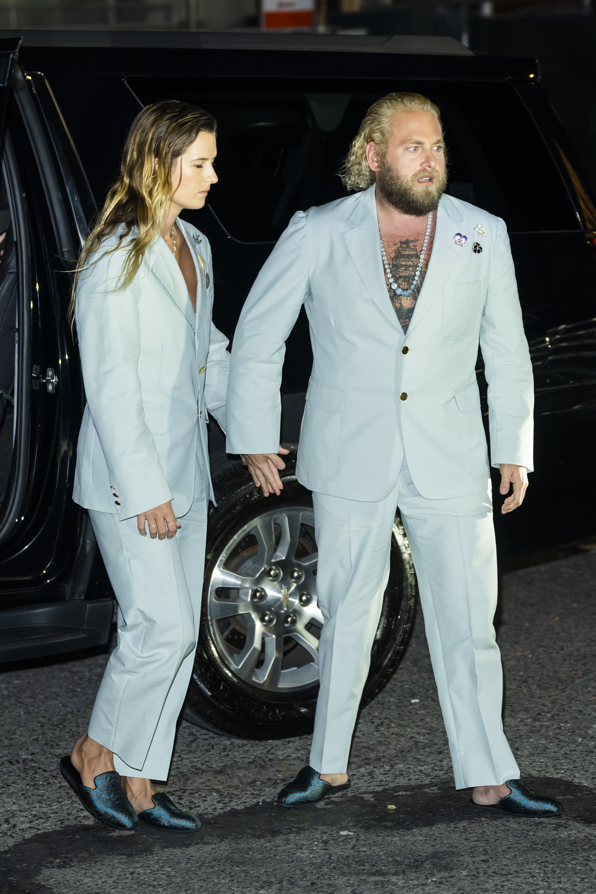 Close-up of Jonah and Sarah outside wearing matching suits