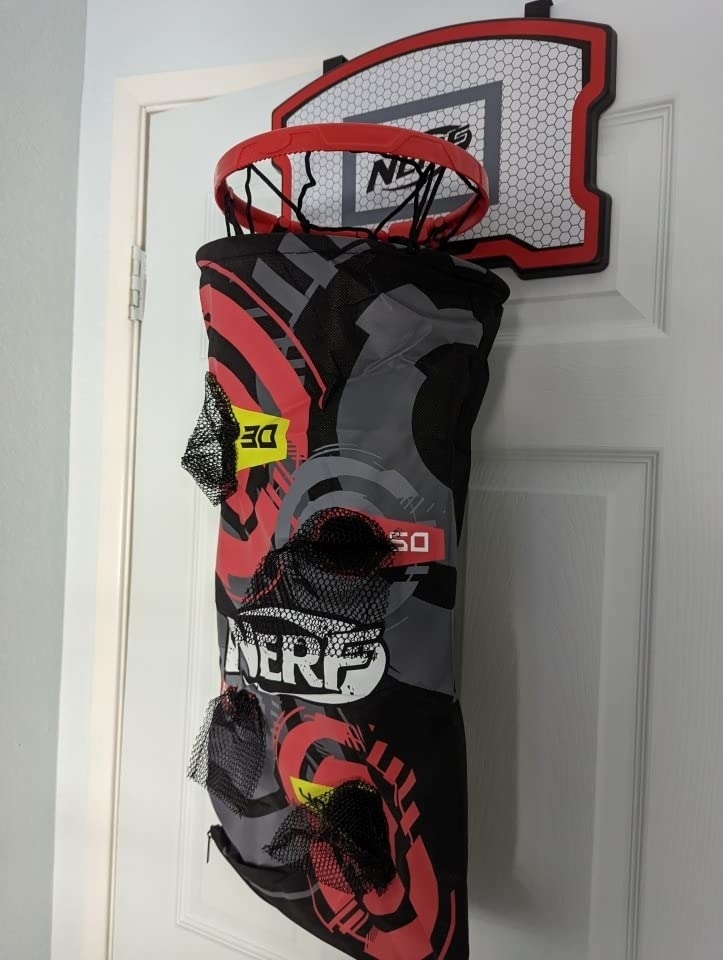 Reviewer&#x27;s photo of of black and red Nerf basketball hamper hanging from closet door