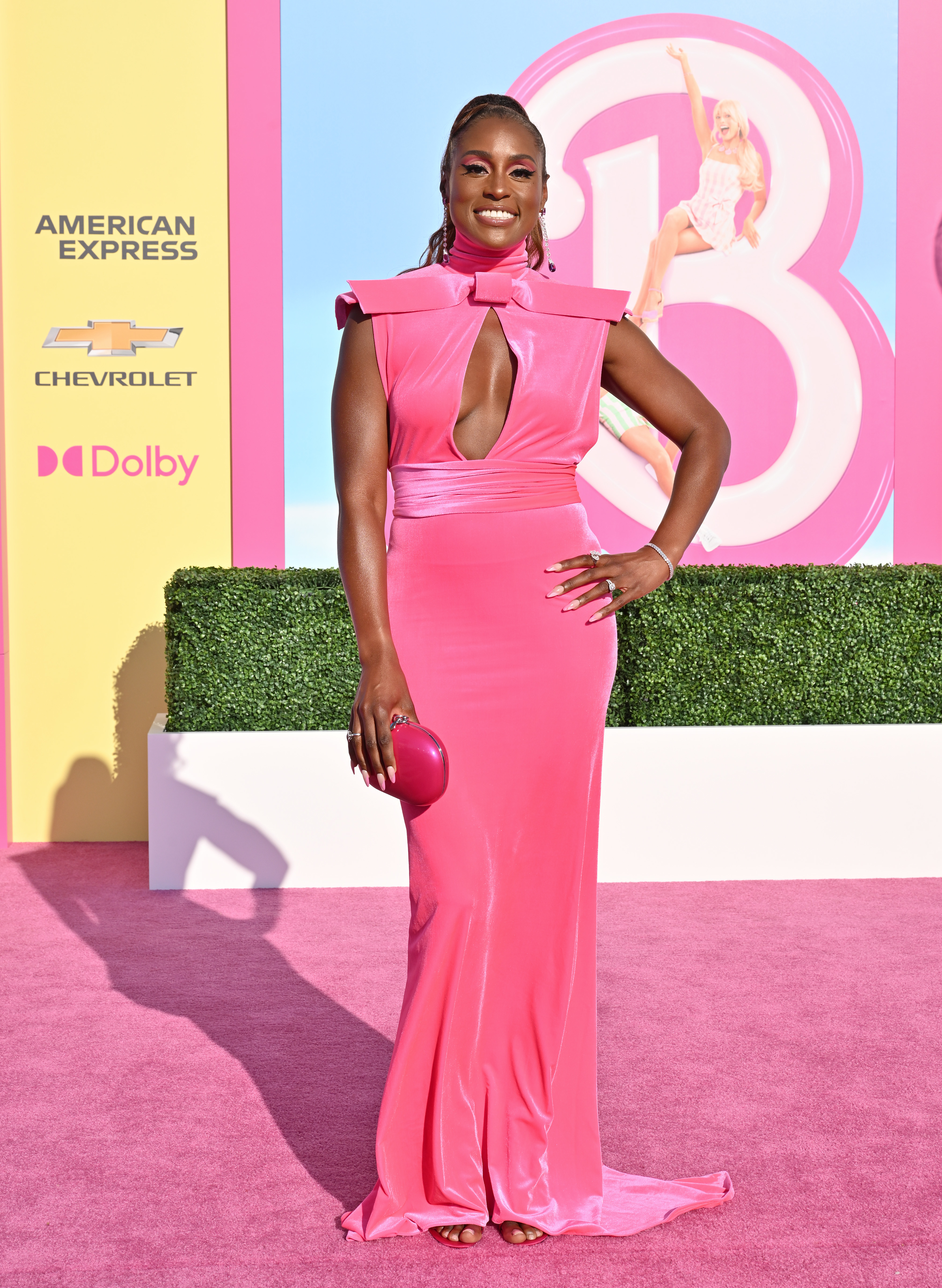 In a pink sleeveless gown