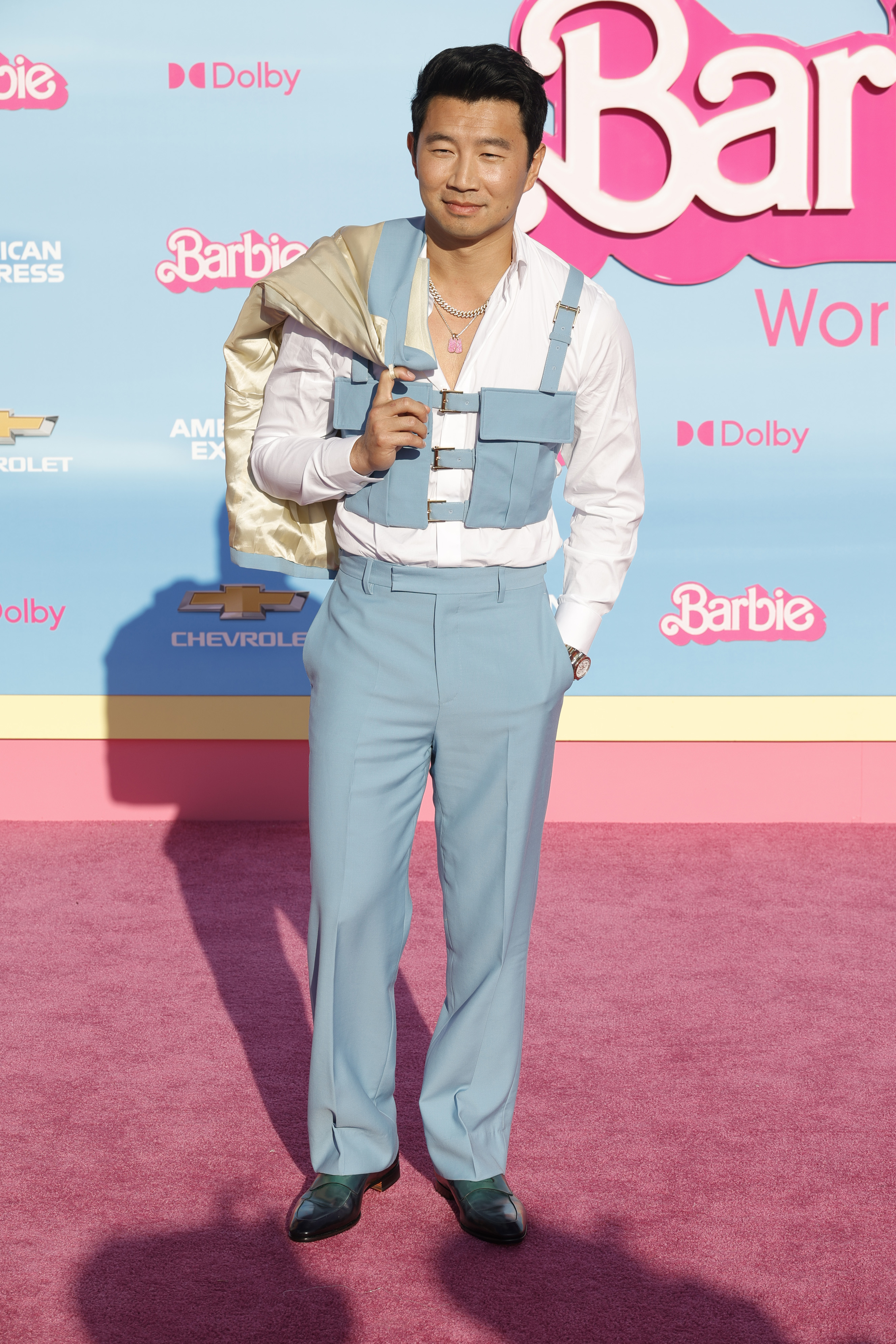 In a light blue suspender vest and matching pants, with a lighter jacket and shirt