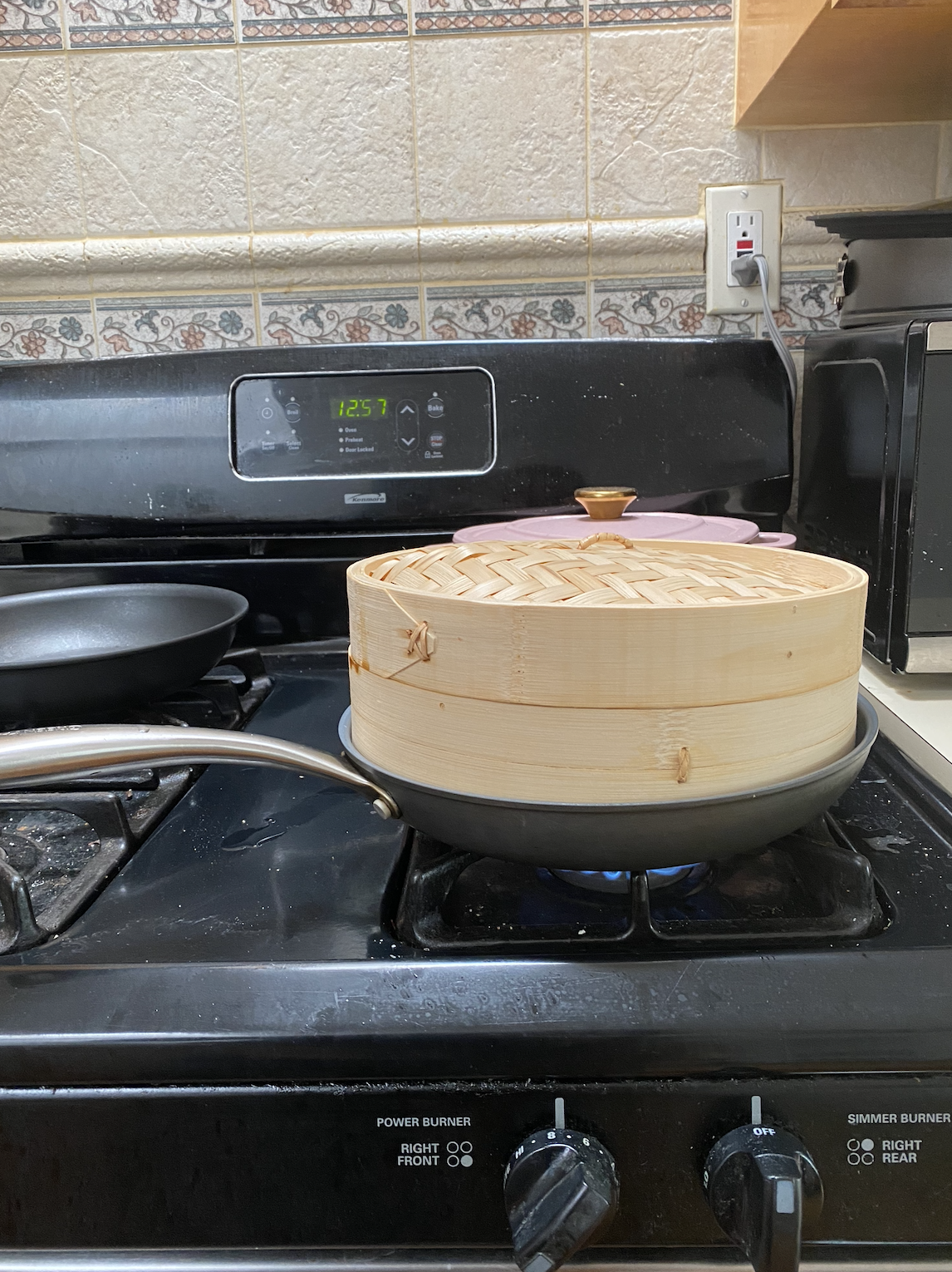 bamboo steamer and pan on top of stove