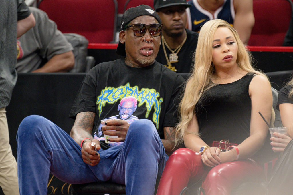 The couple sitting side-by-side at a basketball game