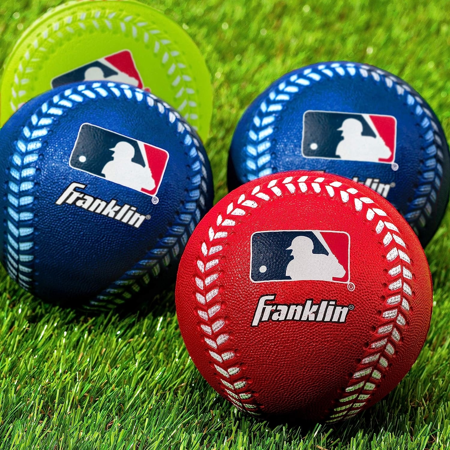 A red, a green, and two blue foam baseballs