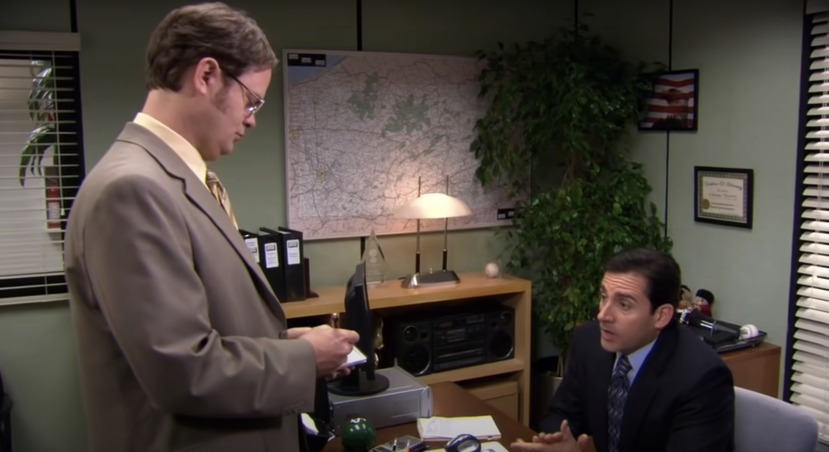 Rainn standing as Steve Carell talks to him in a scene from &quot;The Office&quot;