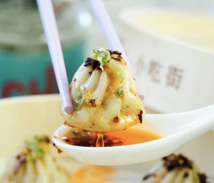 close up of soup dumpling with chili oil on it