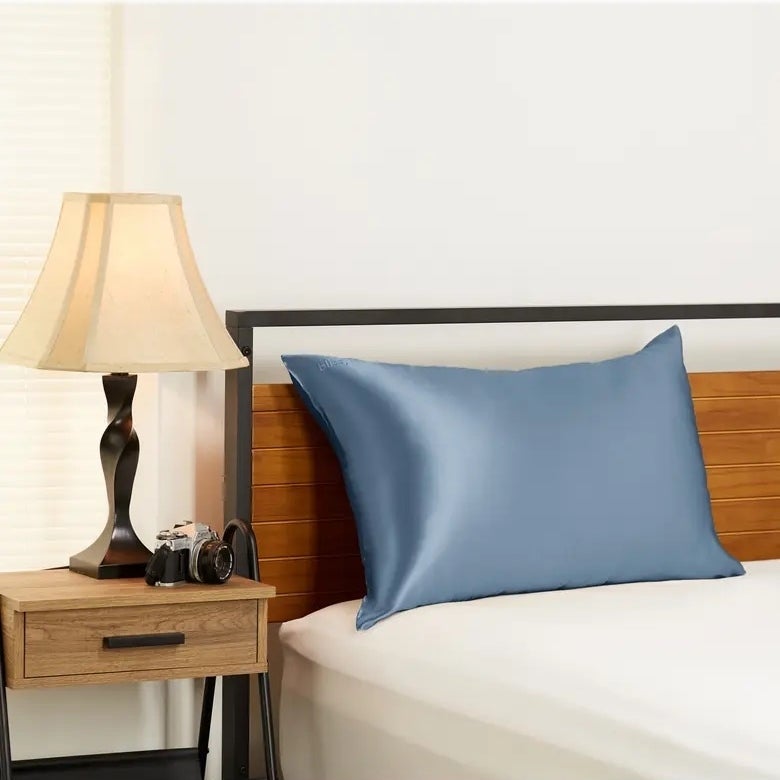 A light blue pillow on a bed