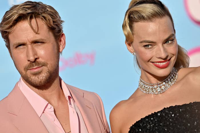 Ryan Gosling, on the left, standing next to Margot Robbie on the pink carpet at the premiere
