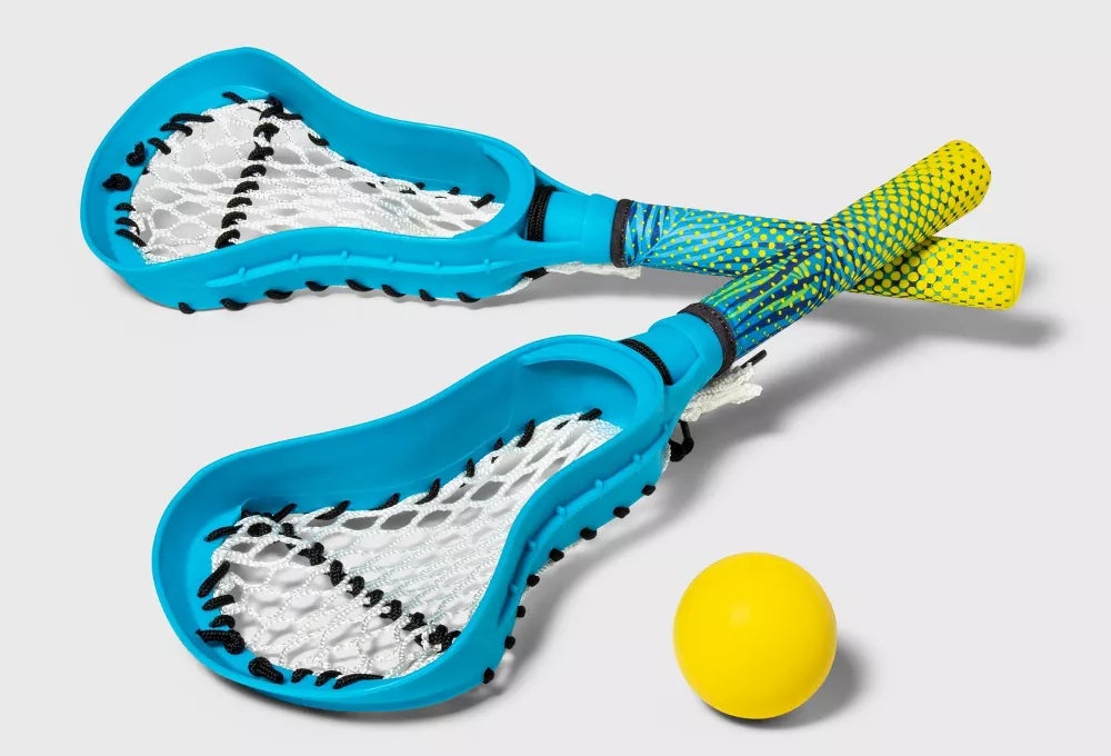 Two blue, green, and yellow small lacrosse sticks with yellow ball
