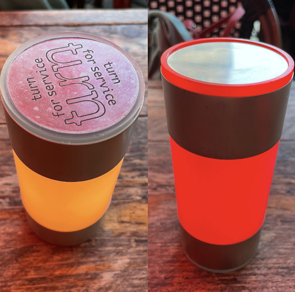 A device that resembles a cup has a top that says &quot;turn for service.&quot; When you turn it, the cup changes colors, which lets the waiter know to come to your table