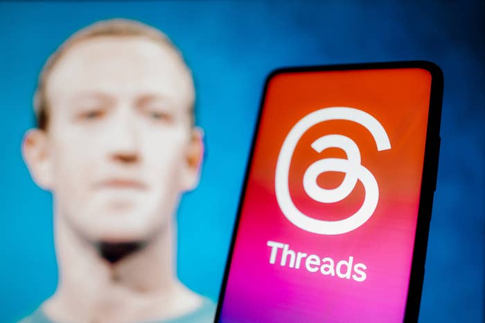 The Threads app with Mark Zuckerberg in the background