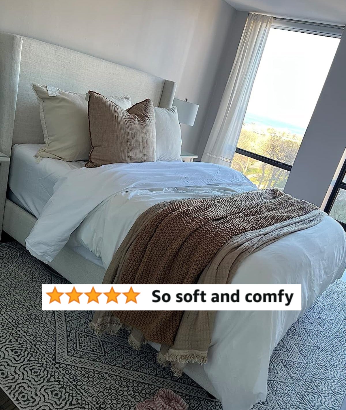A reviewers made bed with white sheets and review text &quot;so soft and comfy&quot;