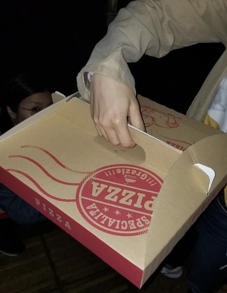 The pizza box includes extra cardboard on the top and sides that fits together to turn into a handle