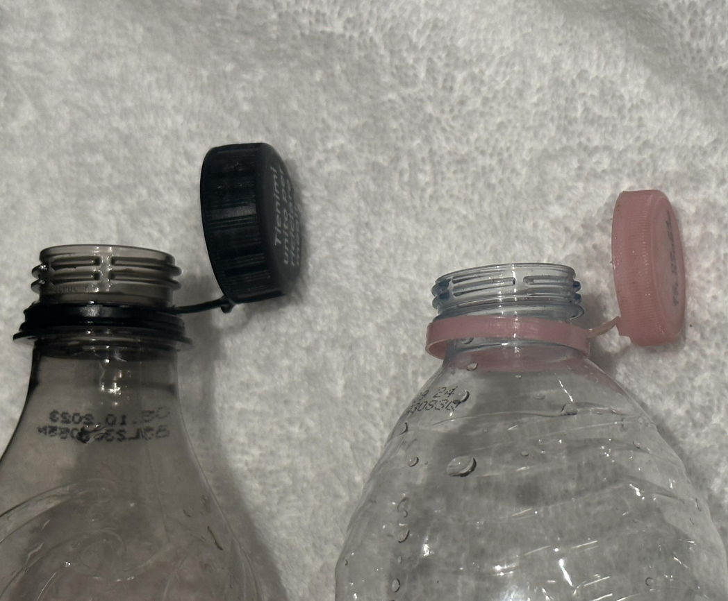 The plastic rings at the top of bottles include an additional strip of plastic that keeps the lid attached