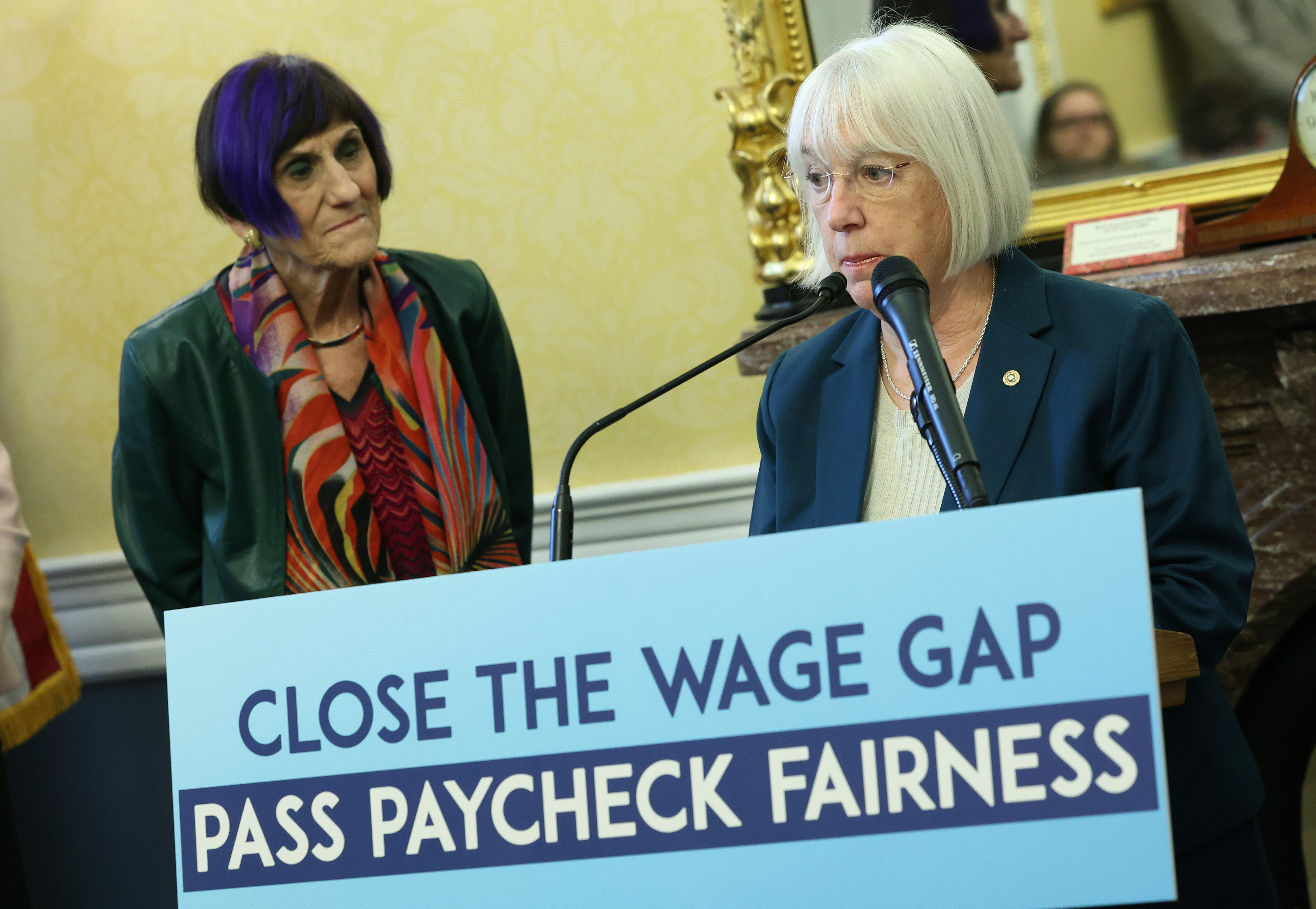 Women with sign that advocates for fair pay