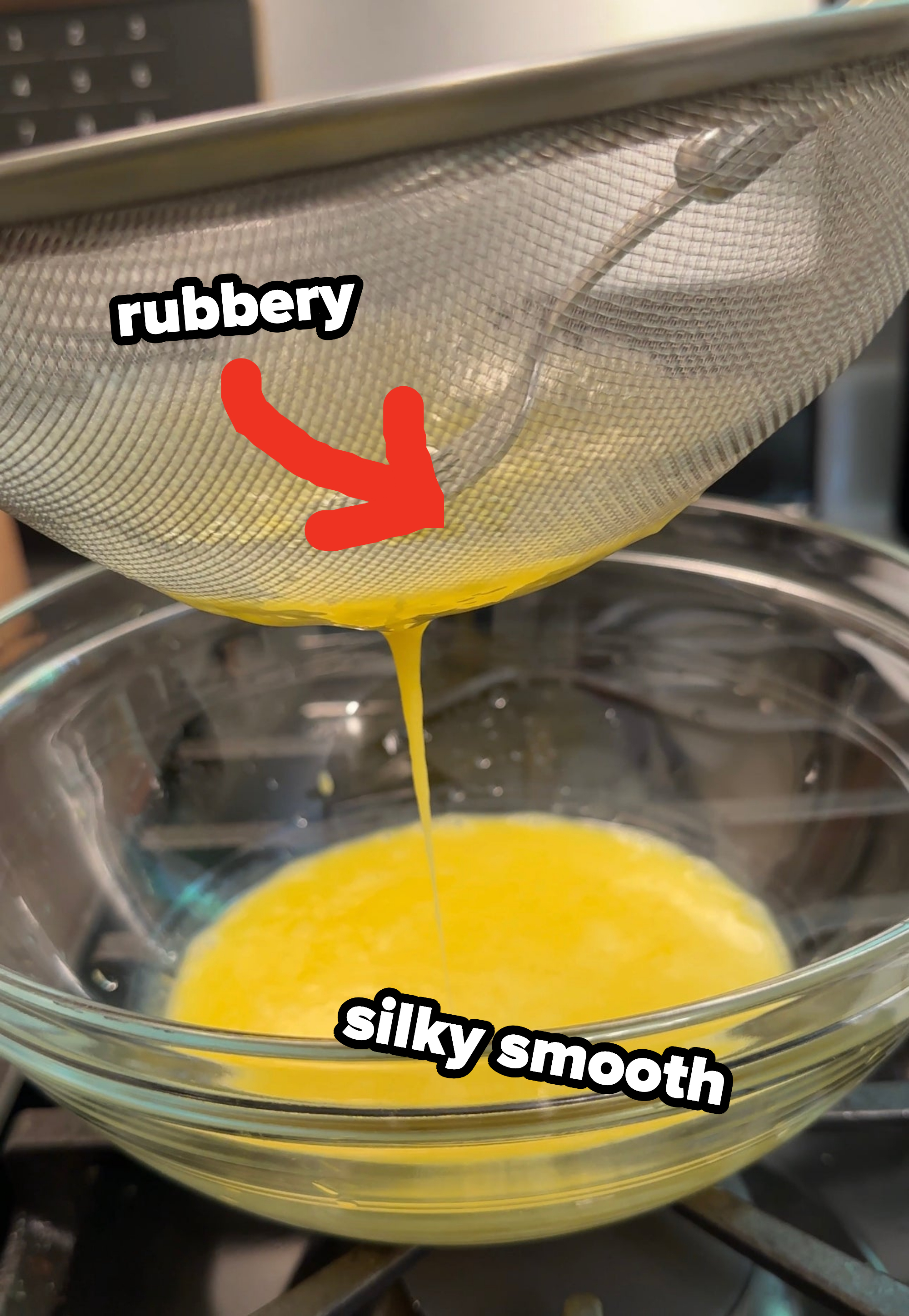 whisking rubbery eggs into a sieve with silky smooth beaten eggs coming out into a bowl
