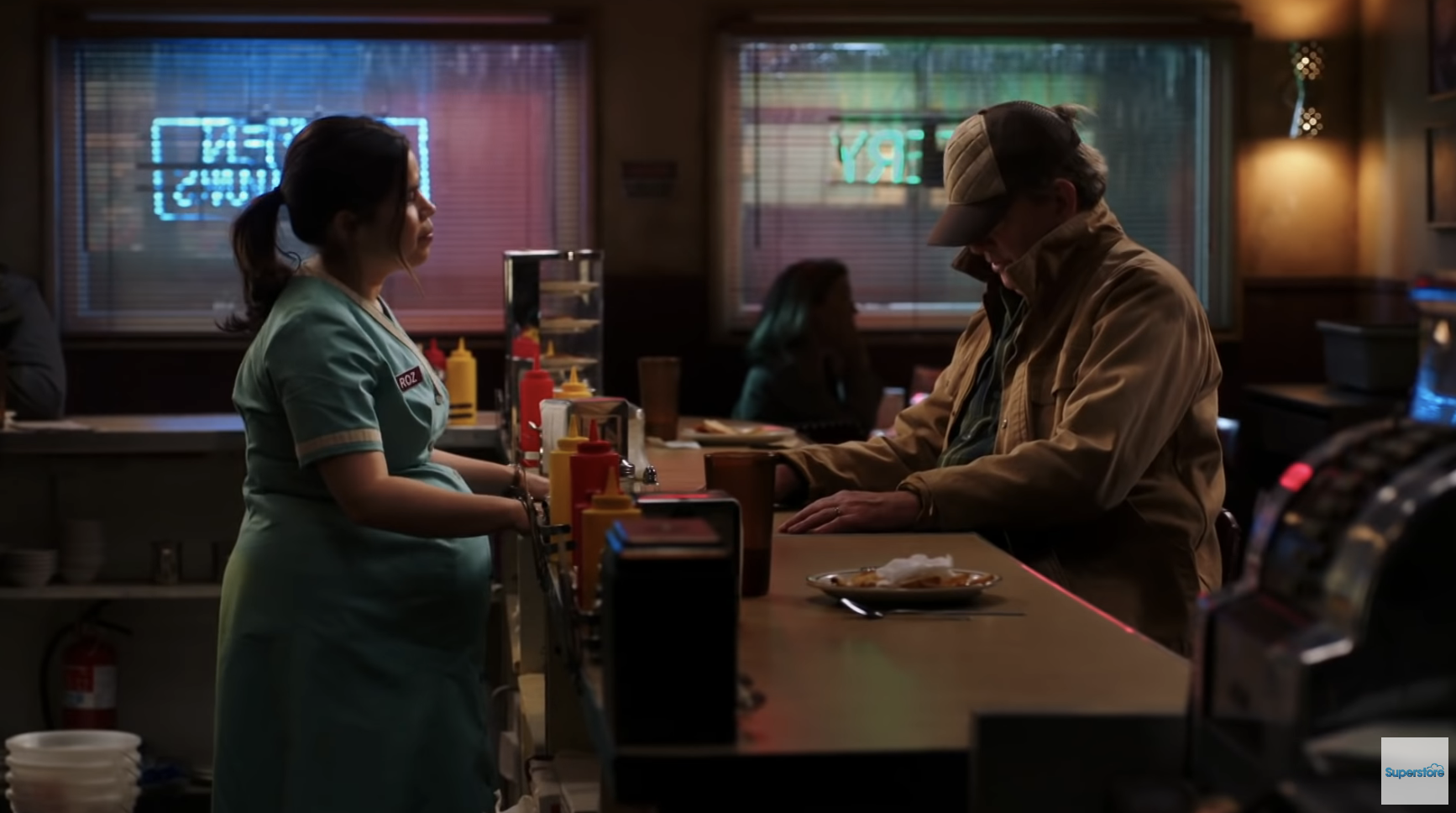 Glenn sits at a diner counter while Amy serves him