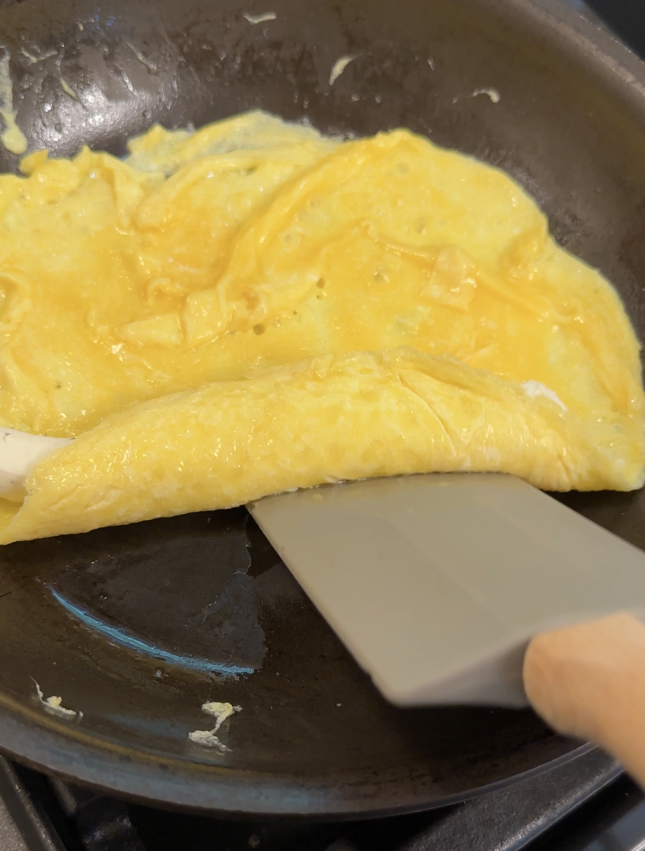 folding up the omelet with a rubber spatula