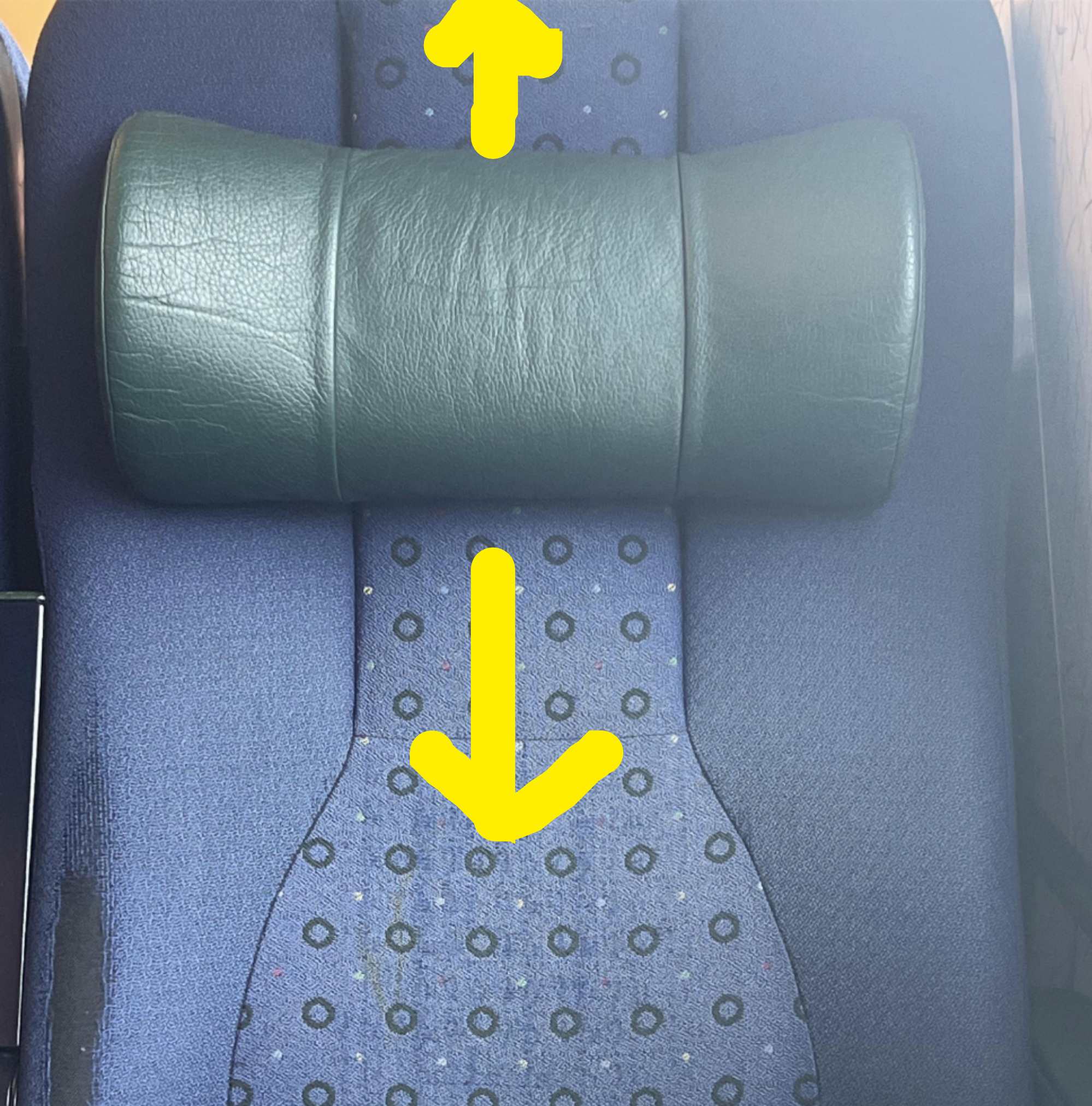 The seat has a headrest that is currently in the middle of the seat and be moved higher or lower, depending on the passenger&#x27;s height