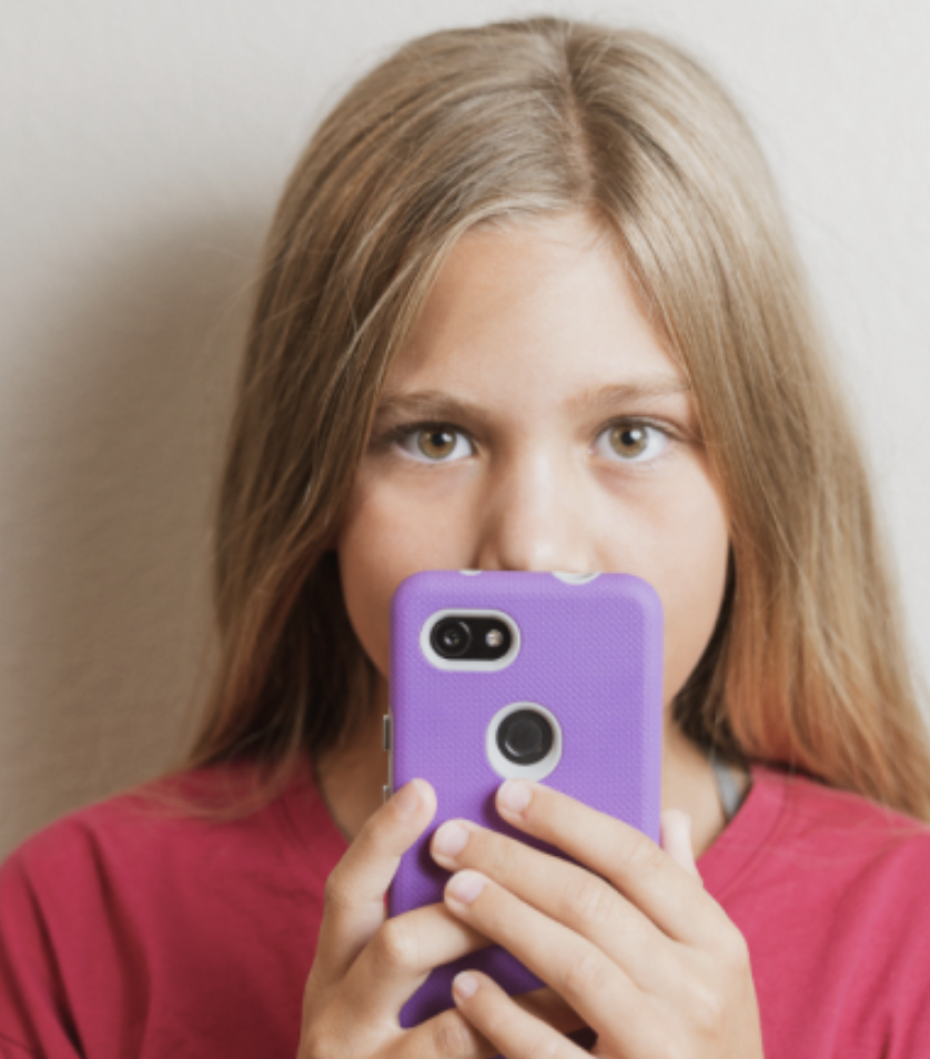 child holding cell phone in front of their face