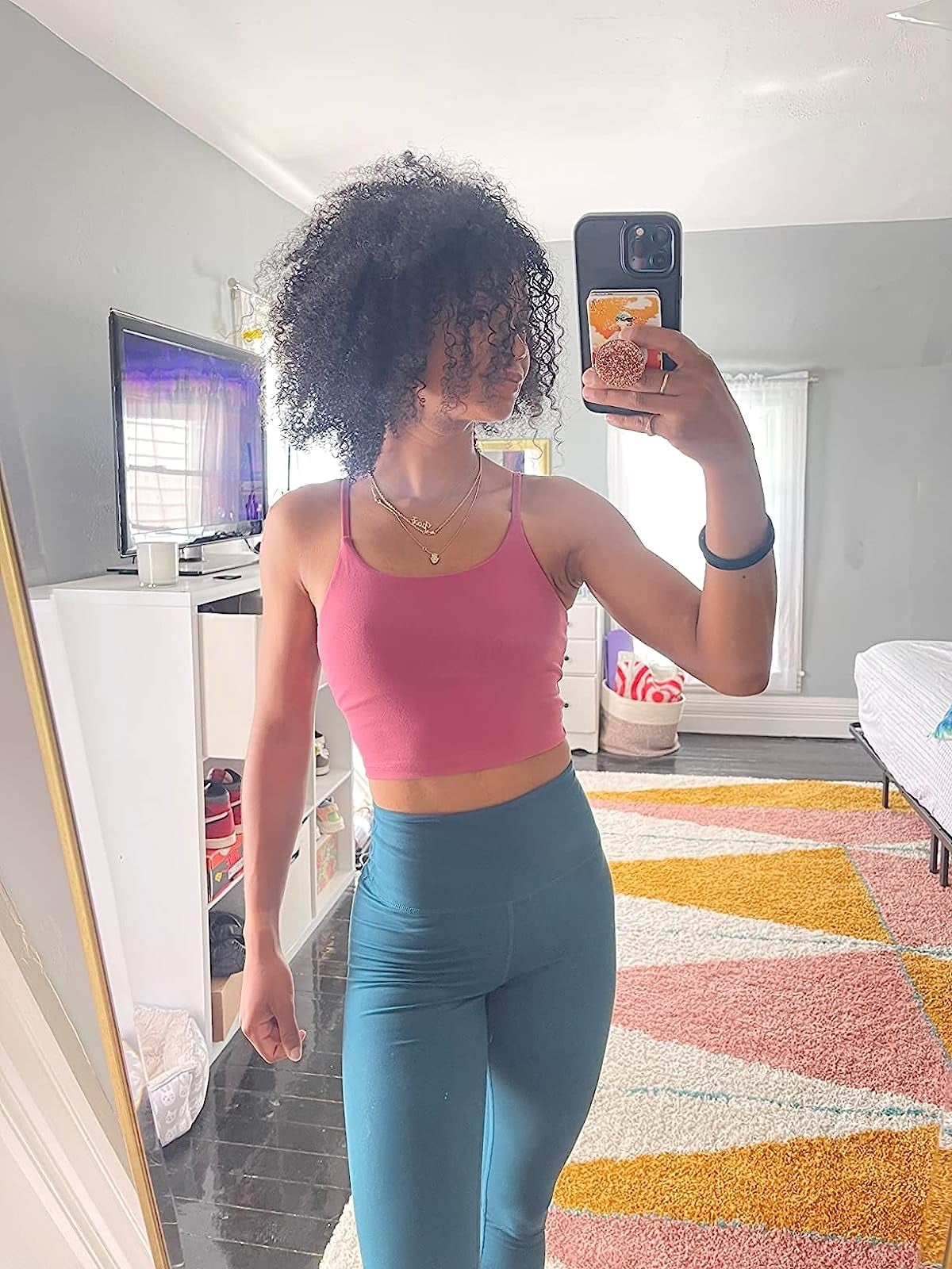 reviewer wearing the bra apical  successful  pinkish  with leggings