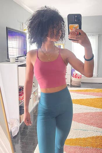 reviewer wearing the bra apical successful pinkish with leggings