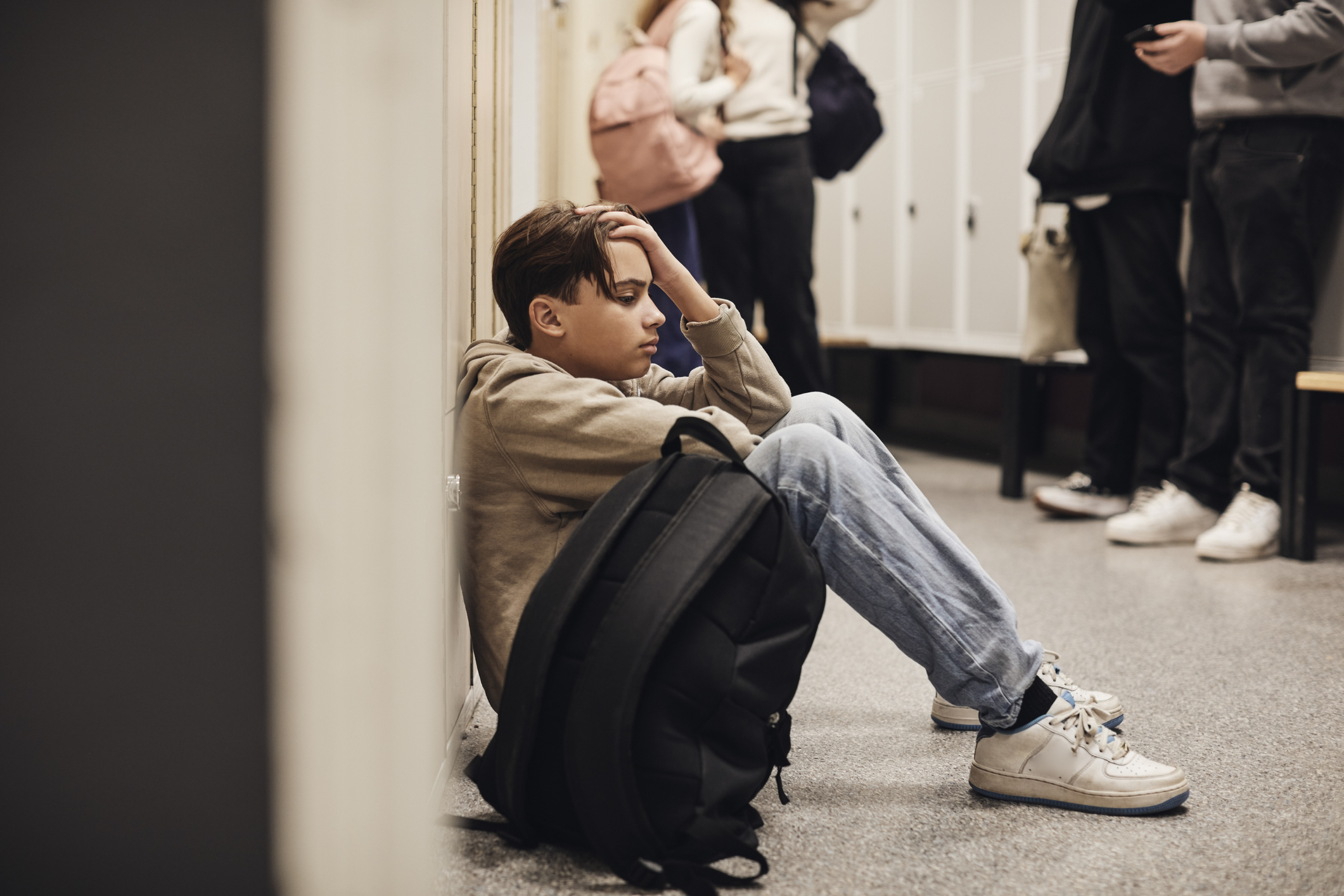 teen on the school hallway floor