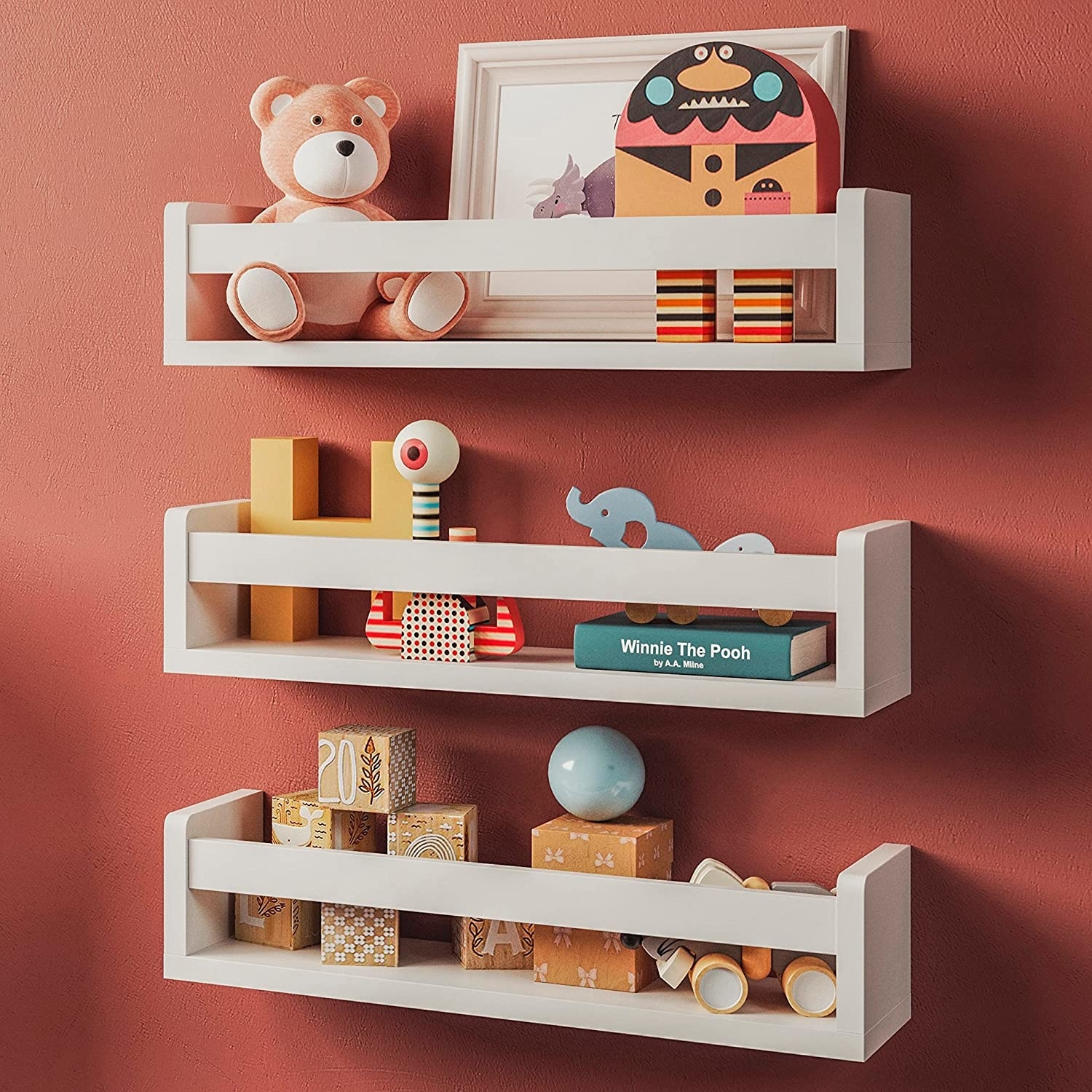 three wooden shelves holding kid toys and books