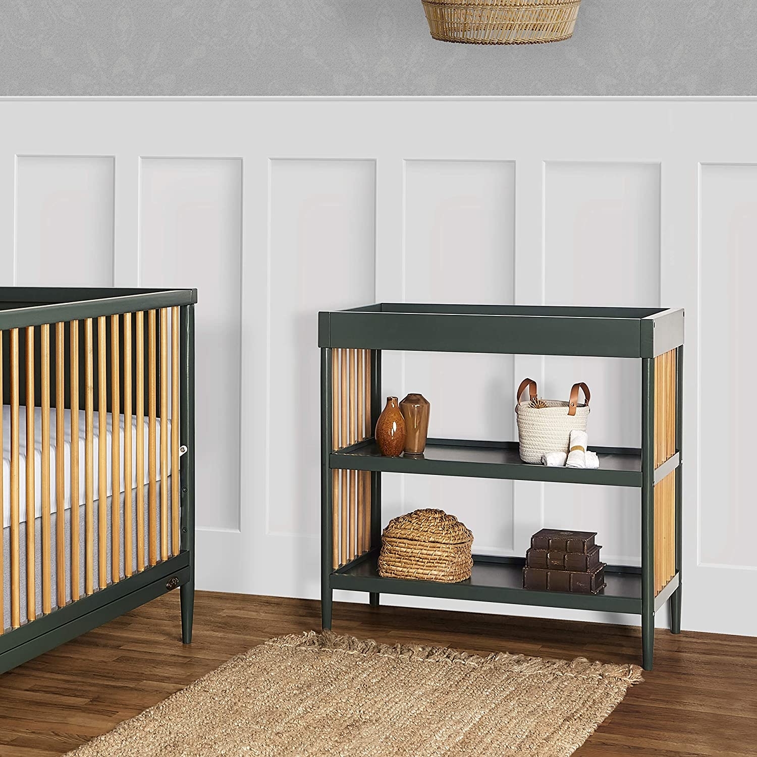 natural wood and green changing table and crib in nursery