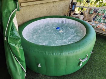 reviewer photo of the green hot tub bubbling