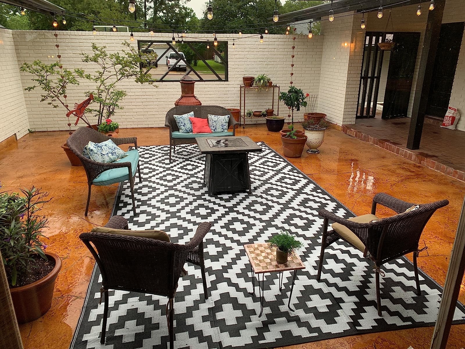 large rectangular rug with a dark gray and white geometric pattern on someone&#x27;s patio