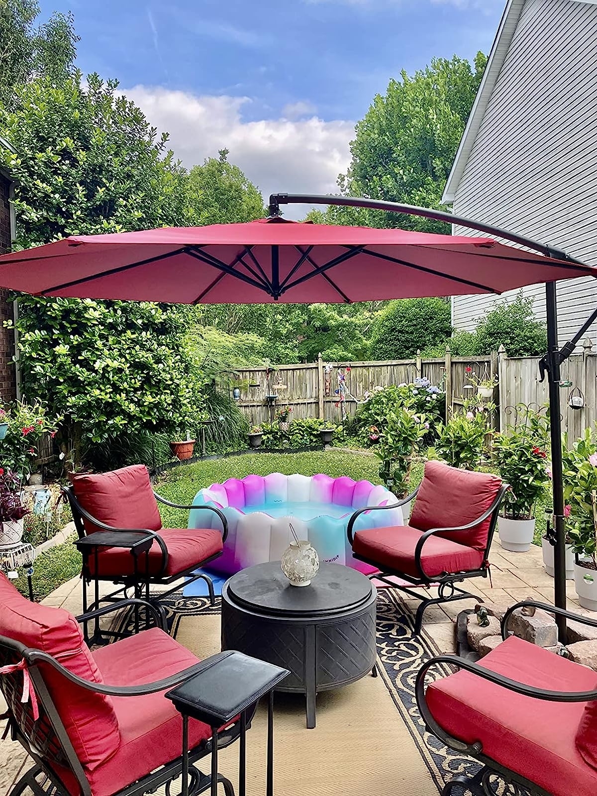 reviewer photo of the red umbrella providing shade for a small table and four chairs