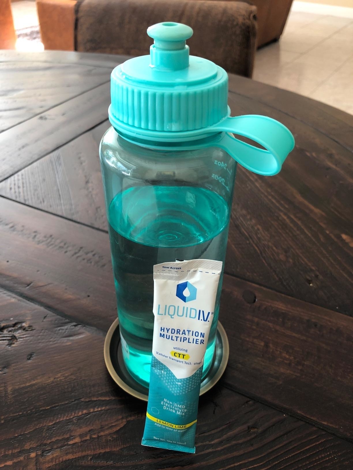 a reviewer photo of a water bottle and liquid I.V. packet