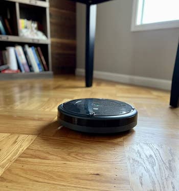 reviewer image of the Roomba on hardwood floors