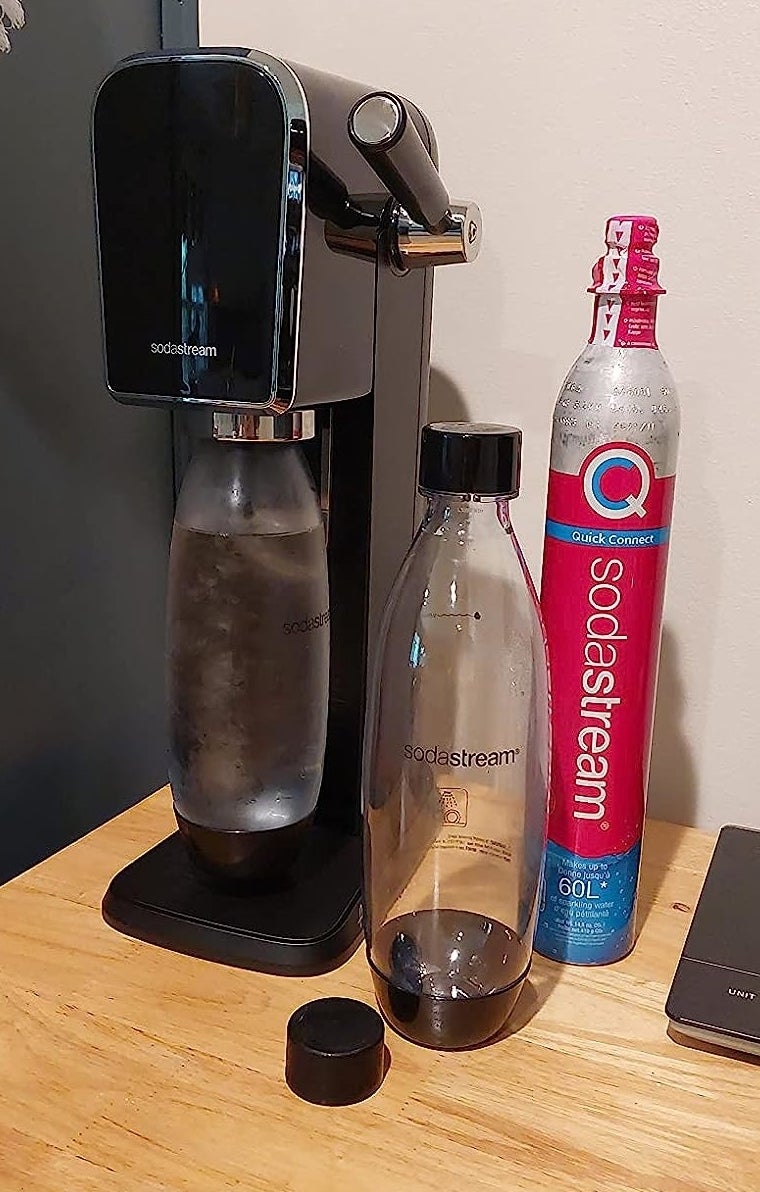 a reviewer photo of the sodastream maker, included bottles, and Co2 cartridges