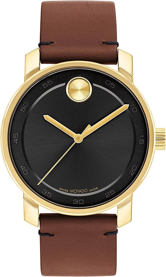 A Movado watch with a black faceless dial and a leather watch band with gold accents.