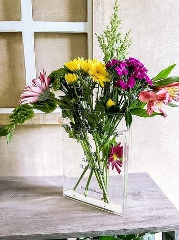 the transparent vase filled with a bouquet