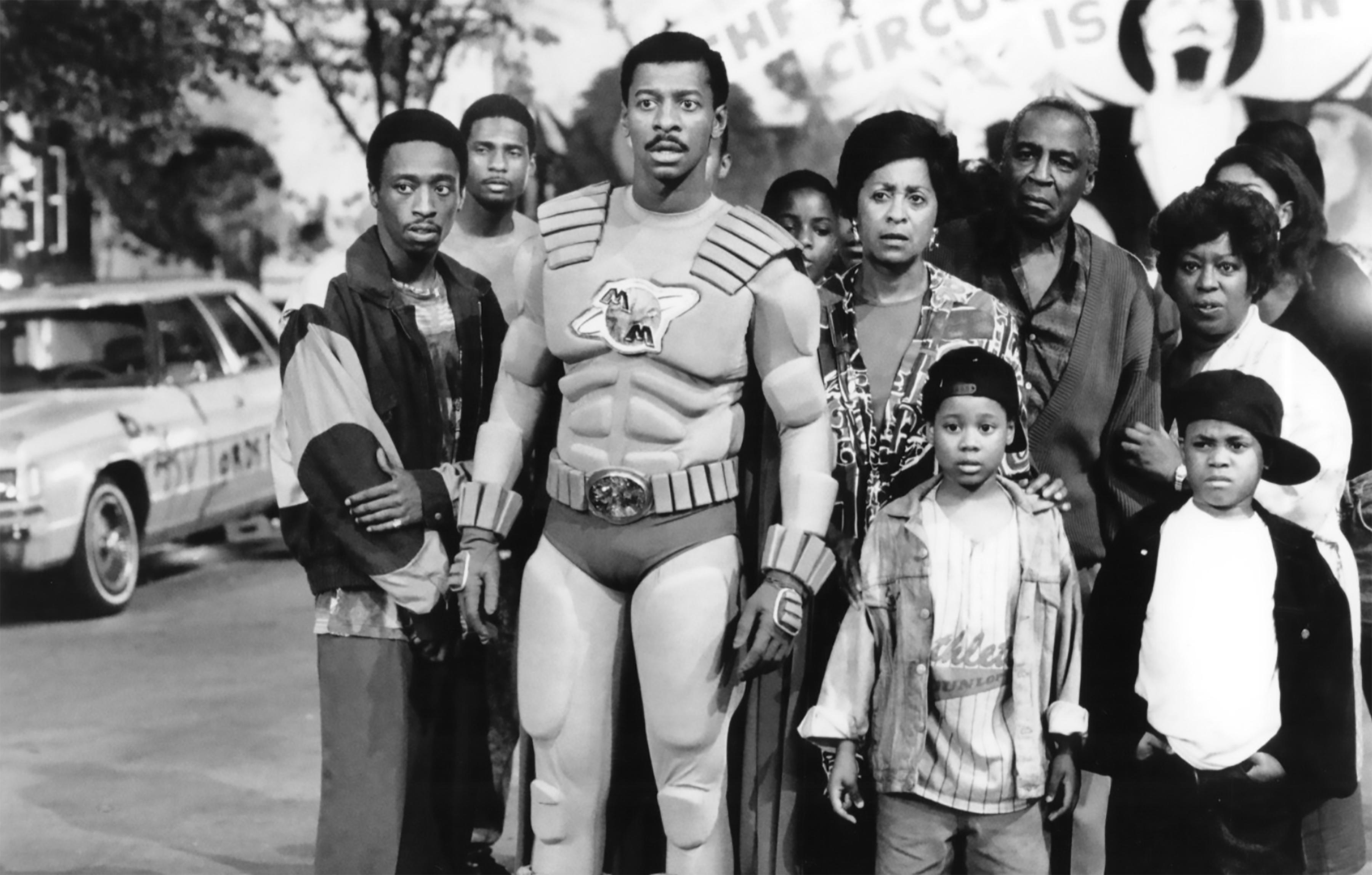 Townsend as Meteor man with a neighborhood of people behind him