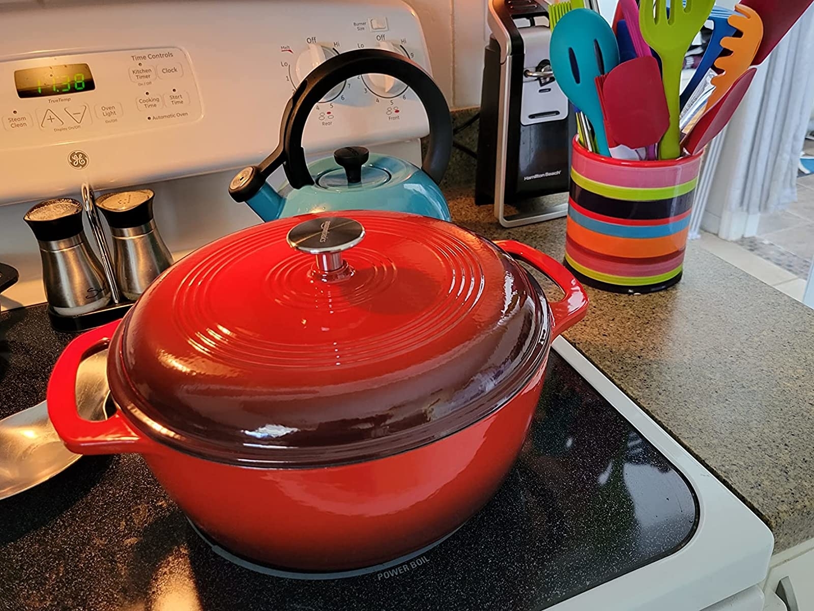 reviewer&#x27;s red enameled cast iron dutch oven on a countertop